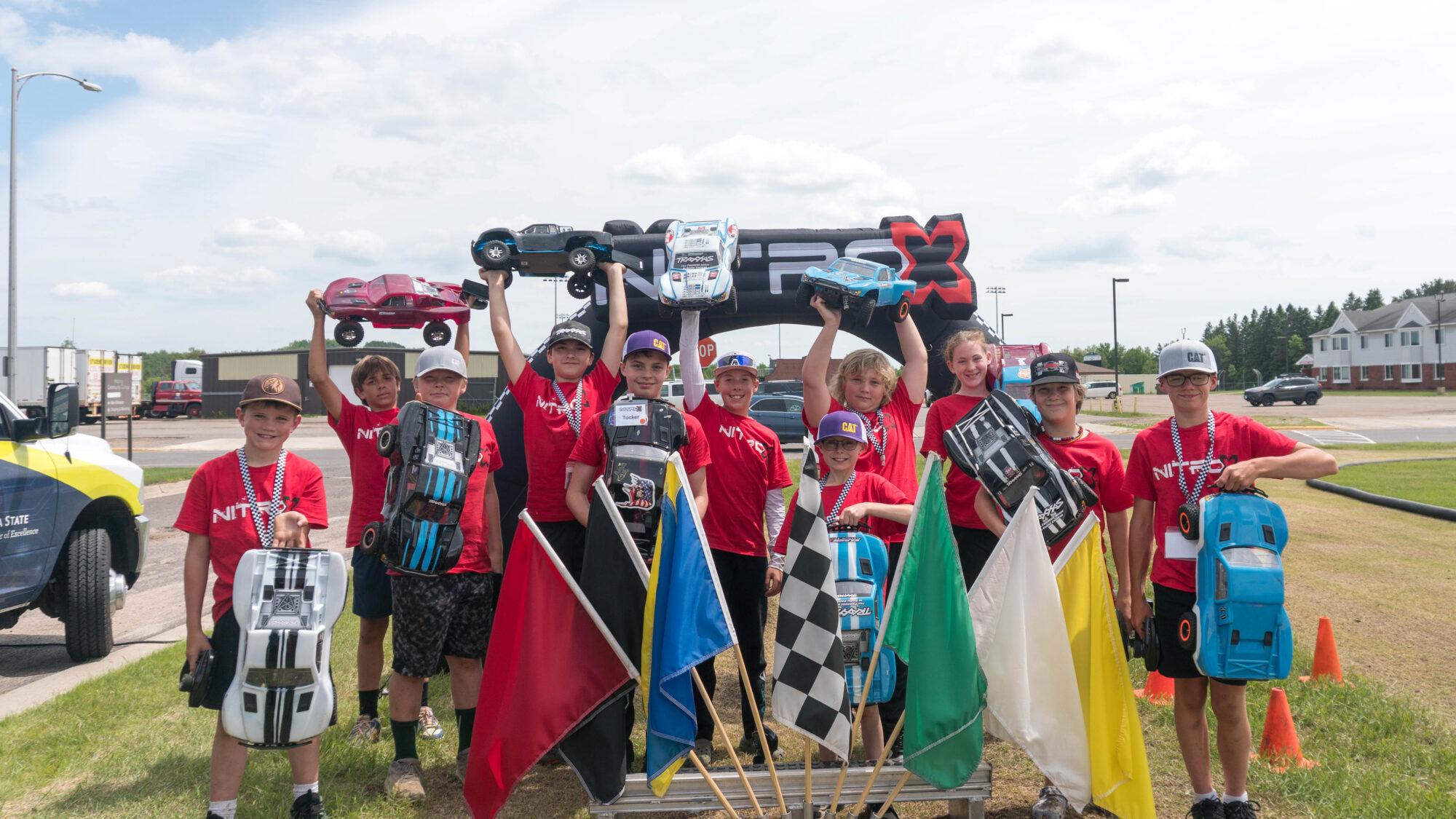 smiling campers holding up RC cars